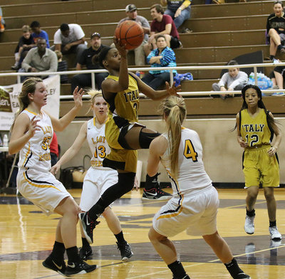 Image: Lady Gladiator Decorea Green(3) rises in the lane to put up a shot over a hive of Lady Hornet defenders.