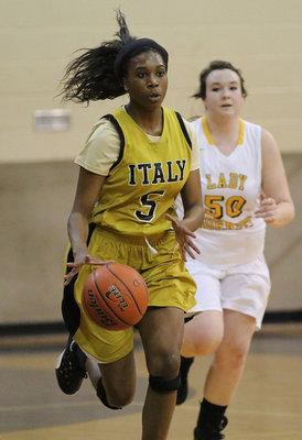 Image: Senior Janae Robertson(5) sprints the ball up the court for the Lady Gladiators.