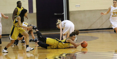 Image: The Lady Gladiators were all in as Emmy Cunningham(2) dives for the loose ball and then pushes it to teammate Ta’Keya Pace(12).