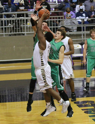 Image: Gladiator Kenneth Norwood(3) is fouled while charging to the basket against Valley View.