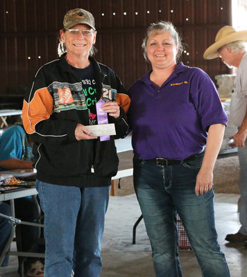 Image: Nancy Mitchell is presented a check for $80.00 and participation ribbon from Flossie Gowin for winning the Beans challenge during the 2016 Italy Lions Club BBQ Cook-off.