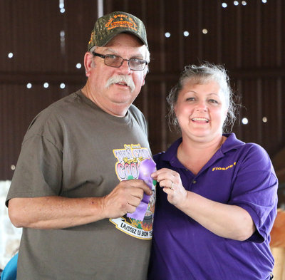 Image: Italy Lions Club member Flossie Gowin presents David Leflere with his 10 Place participation ribbon in the Brisket competition. Leflere also placed 5th in the Pork Butt competition and 6th in the Ribs competition.