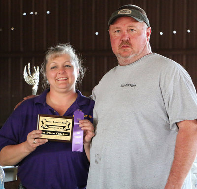 Image: Italy Lions Club member Flossie Gowin presents John Morgan with his 1st Place Chicken plaque and his participation ribbon. 1st Place paid $210.00.