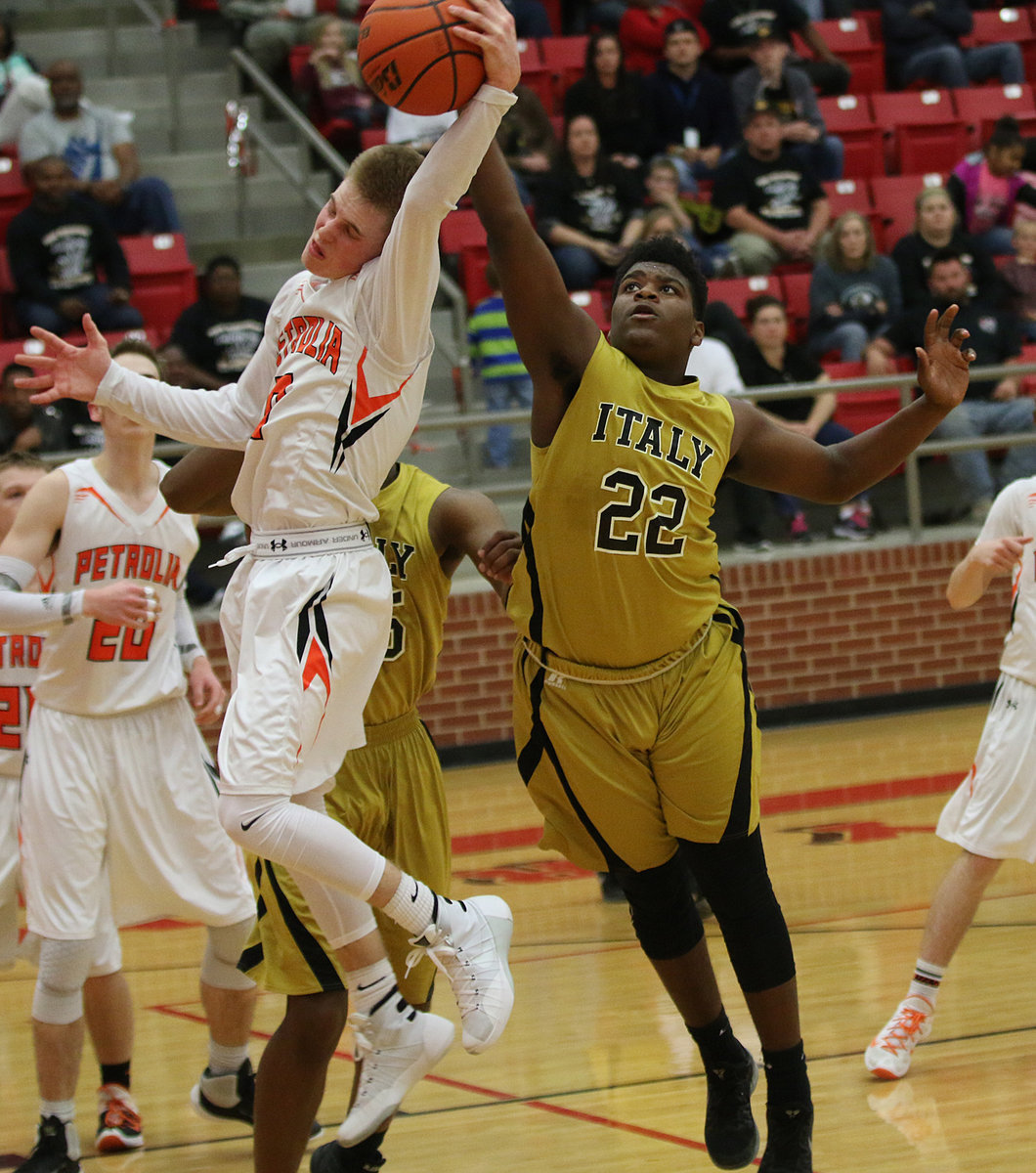 Image: Italy Gladiator freshman Christion Washington tries for a rebound against Petrolia.