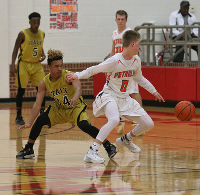 Image: Italy Gladiator Jeremiah Thompson tries to turn back Petrolia’s point guard during the area playoff game.