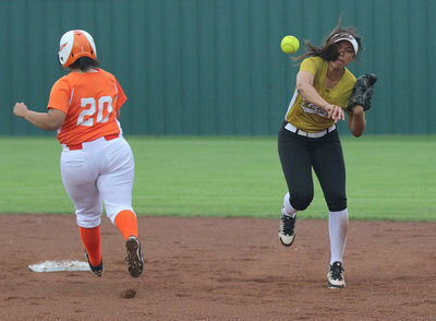 Image: Lady Gladiator shortstop April Lusk attempts to pull off a double-play.