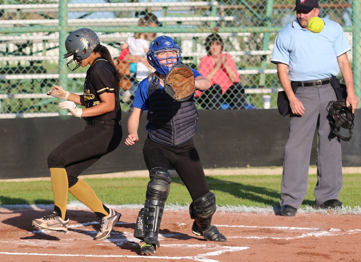 Image: April Lusk(7) outruns the throw to home to score a another run for Italy.