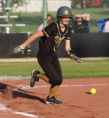 Image: The speedy Taylor Boyd(5) bunts and then races safely to first-base.