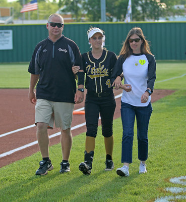 Image: Italy Lady Gladiator senior Britney Chambers is escorted by her parents before the game while being honored during Senior Day at Johnny Jones Field.
