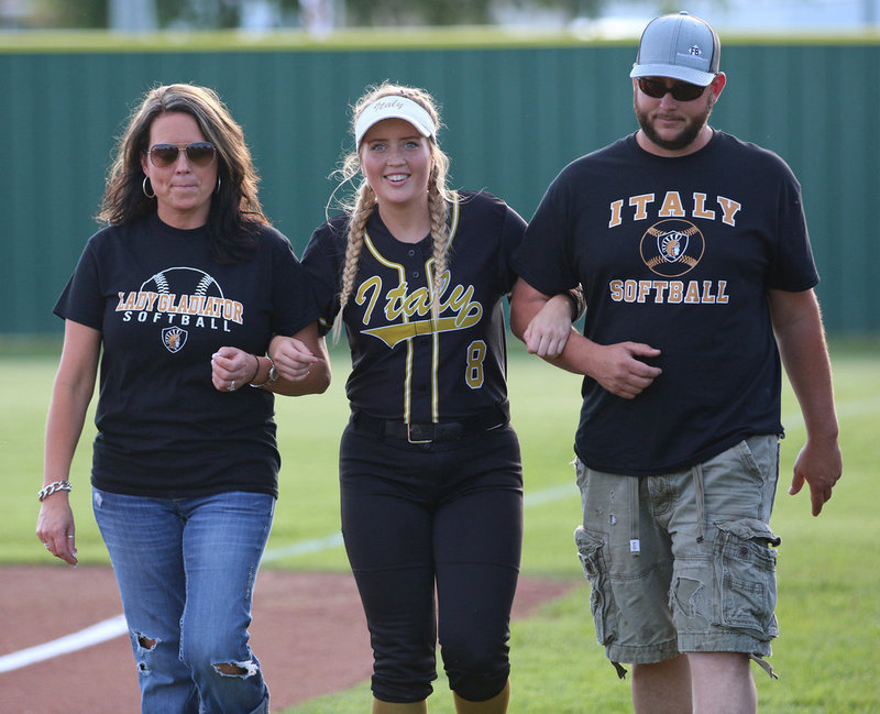 Image: Italy Lady Gladiator senior Hannah Washington is escorted by her family before the game while being honored during Senior Day at Johnny Jones Field.