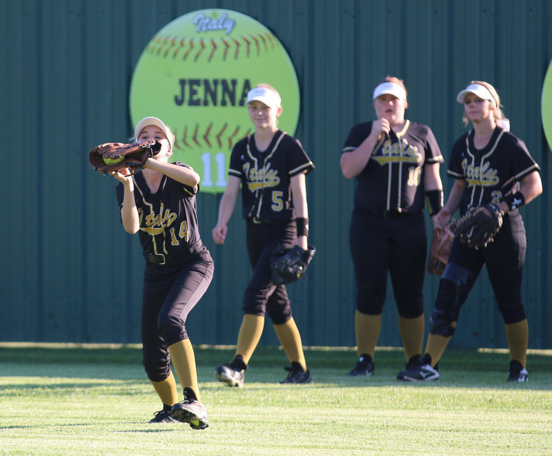 Image: Lady Gladiator Karley Nelson(14) shags a fly ball before the game against Covington.