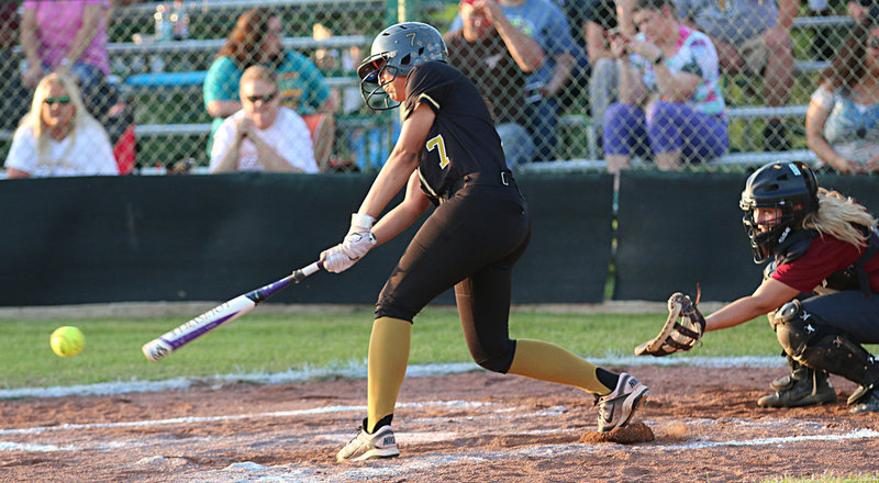 Image: Lady Gladiator April Lusk(7) digs one out to reach first-base safely.