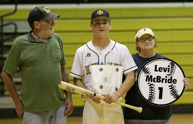 Image: Senior Italy Gladiator Baseball member Levi Gladiator(1) is escorted by his parents, Darlene and Darrell McBride for Senior Night during a post-game ceremony.