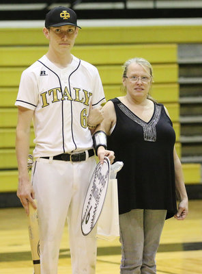 Image: Senior Italy Gladiator Baseball member Clayton Miller(6) is escorted by his mother, Jennifer McKinney Walls, for Senior Night during a post-game ceremony.