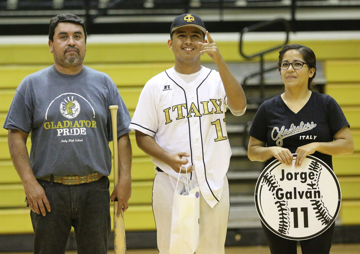 Image: Senior Italy Gladiator Baseball member Jorge Galvan(11) is escorted by his parents for Senior Night during a post-game ceremony.