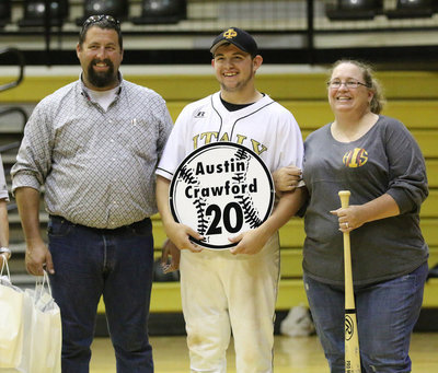 Image: Senior Italy Gladiator Baseball member Ty Windham(12) is escorted by his parents, Heidi and  Phillip Crawford, for Senior Night during a post-game ceremony.