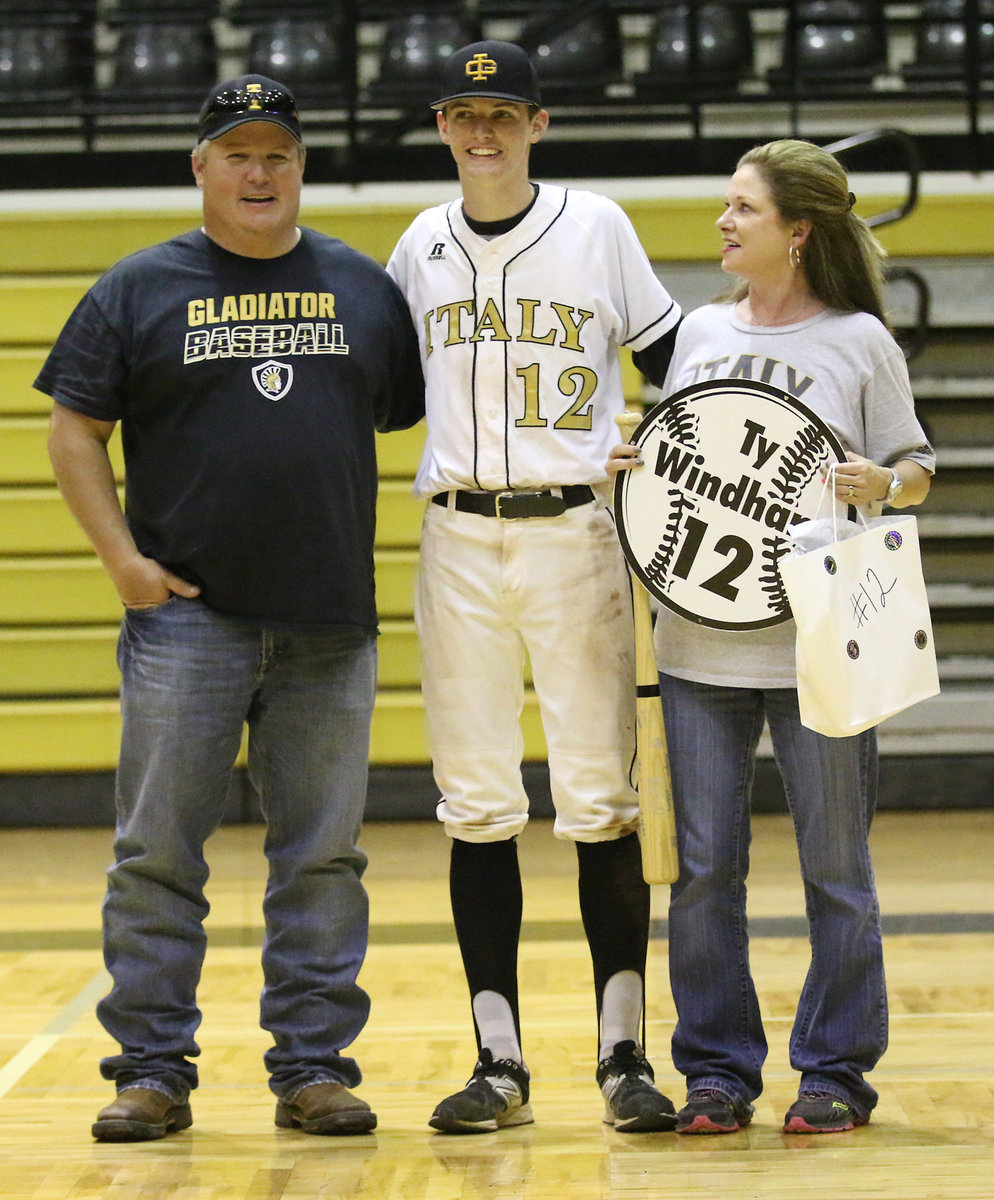 Image: Senior Italy Gladiator Baseball member Ty Windham(12) is escorted by his parents, Andi and Joe Windham, for Senior Night during a post-game ceremony.