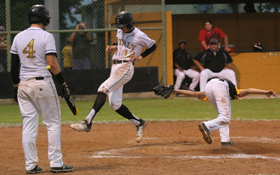 Image: Micah Ecamilla(4) looks on as fellow senior Ty Windham(12) high steps his way across home plate to complete Italy’s 2016 district campaign with a 14-1 win over Itasca.