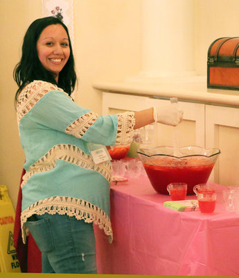 Image: Trinity’s Rosanna Wooldridge (Italy) pours the Mother’s Day punch for the residents and their friends and family members.