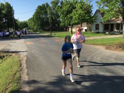 Image: Lea Staggs and Mrs. Simon finish the run together.