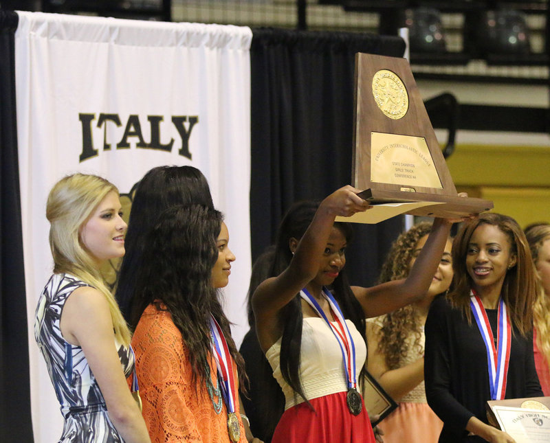 Image: Freshman Chardonae Talton does the honors on behalf of her state champion track teammates as she hoists the 2016 Conference AA UIL State Championship trophy high for Italy fans upon which to gaze during the Italy Athletic Department’s spring banquet.