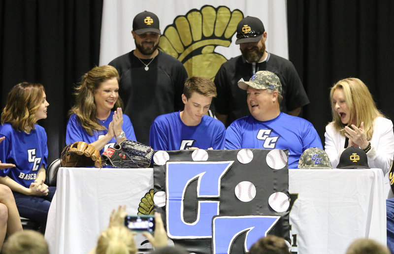 Image: Italy High School senior pitcher Ty Windham commits to Cisco College with the roar of the fans as his baseball coaches Daniel Weaver and Mitchell Blake, parents Andi and Joe Windham, sister Drew Windham (left) and grandmother Joanna Windham (right) join the cheers.
