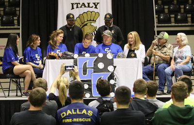 Image: Italy senior Ty Windham begins to make it official as he commits to play baseball for Cisco College as a pitcher. On stage to support Ty during his big moment are (L-R) Sisters Cassi Windham and Drew Windham, mother Andi Windham, Italy head baseball coach Daniel Weaver, assistant baseball coach Mitchell Blake, father Joe Windham, grandmother Joanna Windham, and grandparents Joe WIndham, Sr. and his wife Billye Windham.