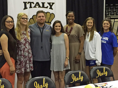 Image: Cedar Valley head volleyball coach Isabel Almendarez, Halee Turner (second from left), Italy AD/HFC David Weaver, Halee’s Lady Gladiator volleyball teammate Cassidy Childers, Italy VB head coach Laquita Walker, North Lake College’s head coach Cathy Carter and assistant coach are Brooke Walker pose for a picture during the commitment ceremony held inside Gladiator Coliseum. Childers (gray and white stripes) signed with Cedar Valley’s rival, North Lake. That should be interesting!