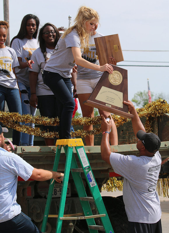 Image: You know you are on top of the world when you need a ladder to get down. Senior Lady Gladiator Halee Turner and her teammates make their way down from the dump truck they paraded in on.