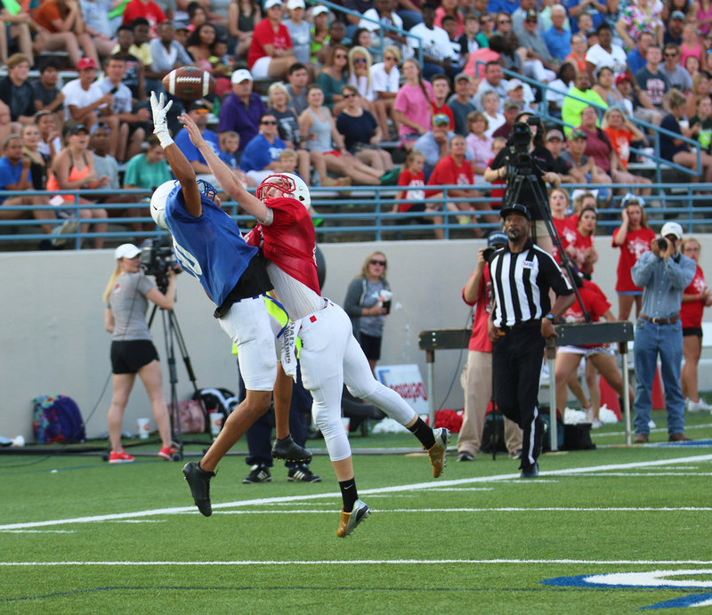 Image: When its nice to have an all-state defensive back as your wide receiver. Red squad’s Clayton Miller(8), of Italy, turns from offense to defense in midair to keep the Blue squad from coming down with the pick.