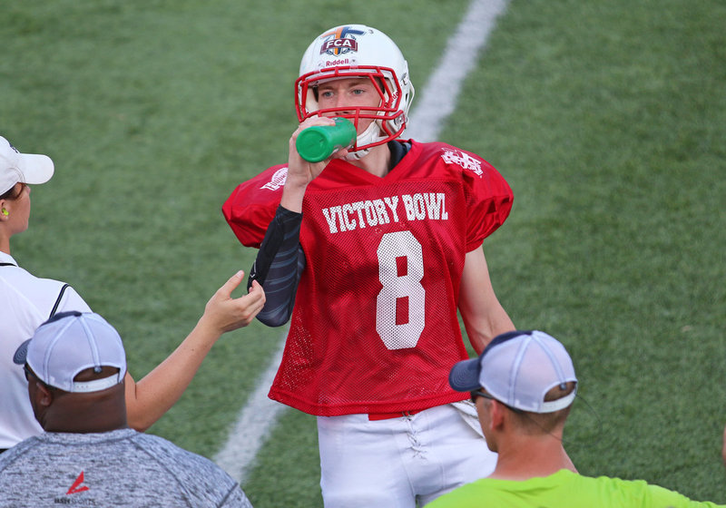 Image: All-star Clayton Miller(8) takes a quick sip during Victory Bowl VIII knowing the game was fixing to swing his way.
