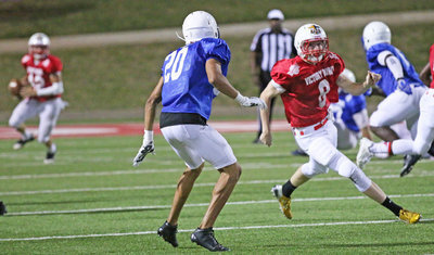 Image: All-star Clayton Miller(8) sprints into action during a rollout pass play to his side of the field.