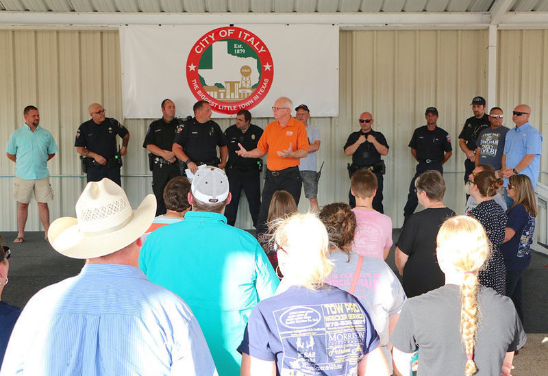 Image: First Baptist Church of Italy Pastor Ronnie Dabney helps lead a prayer vigil inside the pavilion in downtown, Italy, Texas in an effort to keep our community united following the recent tragedy in downtown Dallas where one Dart Police Officer and four Dallas Police Officers were fatally wounded. Seven more officers were also shot as were two civilians.