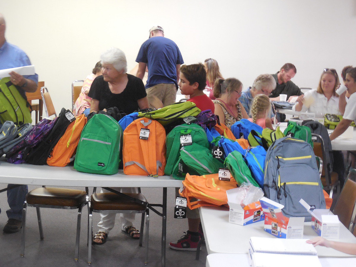 Image: LaDonna Sparks helps pack backpacks.