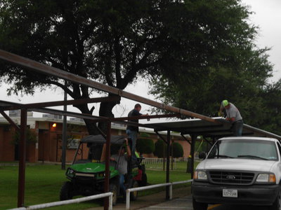 Image: Ken Cate and Brad Chambers attach the awning.