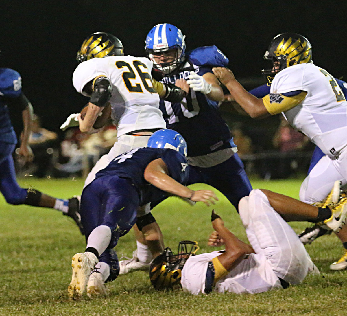 Image: Milford’s #4 Corbin Schrotke squeezes down the gap allowing senior teammate #10 Cole Falzerano to tackle Eagle ball carrier #26 Josh Barnes.