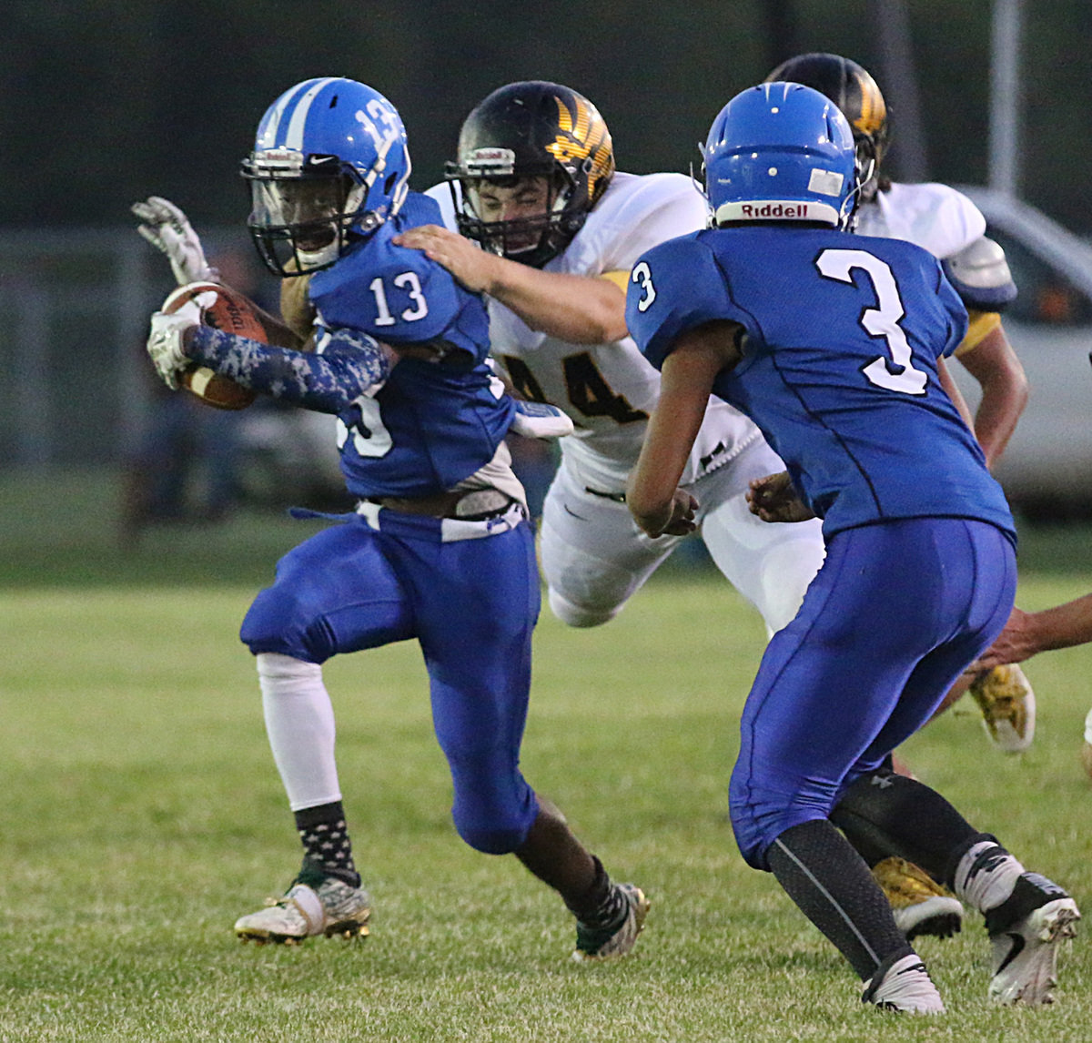 Image: Milford’s #13 James Macintyre scurries for some extra yards-after-the-catch against Jonesboro defense. That’s Eagle defender #44 Jimmy Apodaca flying in for the tackle.