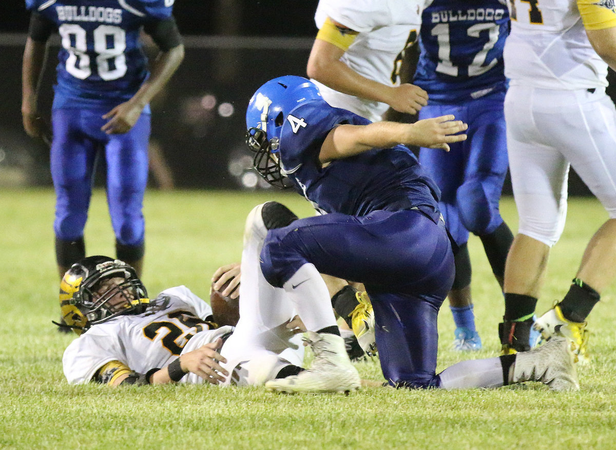 Image: Milford tackler #4 Corbin Schrotke makes quick work of a Jonesboro running back. Schrotke sets the tone for the Bulldog defense with his hard-hitting style of play.