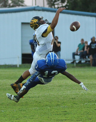 Image: Milford receiver #13 James Mcintyre and Jonesboro Eagle defender #20 Danny Lopez both seem to have taking flight with the Bulldogs trying to execute their passing game early.
