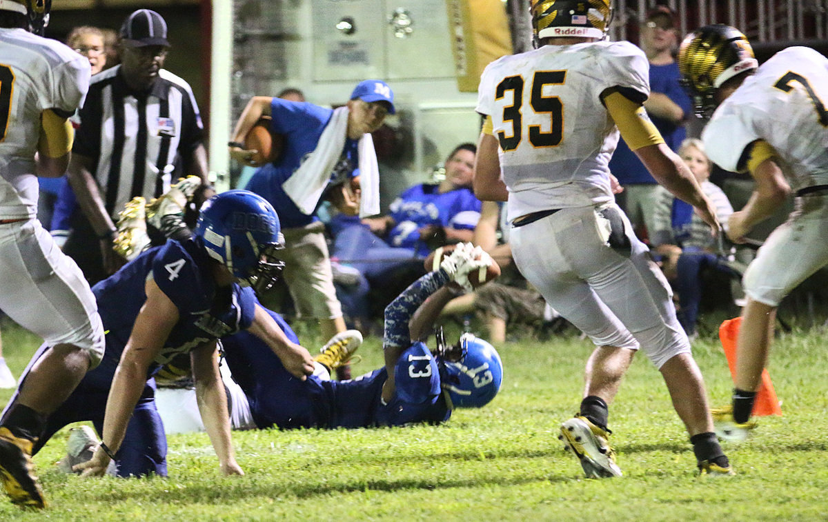 Image: Reciever turned running back #13 James Mcintyre stretches short of the goal line with Milford trying to claim the lead in the fourth-quarter of play.