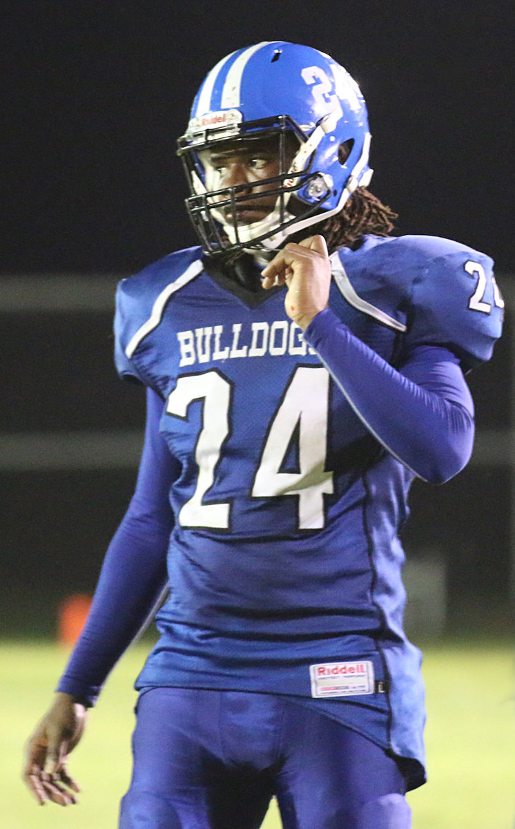 Image: Milford’s senior lineman #24 Jarvis Harris, the biggest Bulldog on the roster at 210 pounds, buckles up to make a defensive stand.