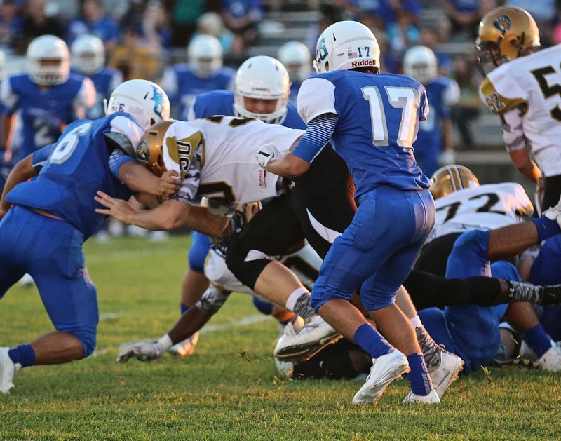 Image: Junior Gladiator #50 Clay RIddle keeps those legs driving while blocking for his backfield.