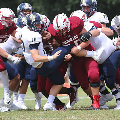 Image: Austin College junior nose guard #50 Zain Byers tackles Howard Payne’s quarterback on fourth-and-short.