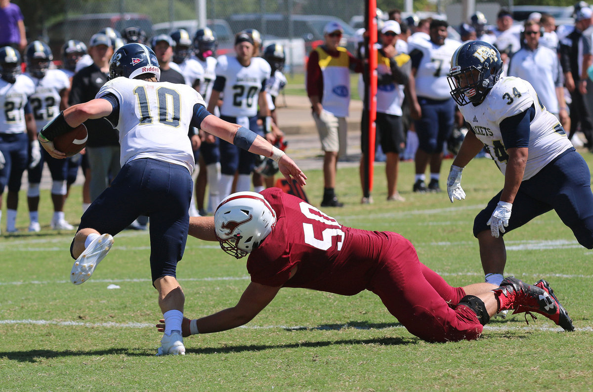 Image: Forcing an incomplete pass late in the game against Howard Payne is Austin College Kangaroo #50 Zain Byers.