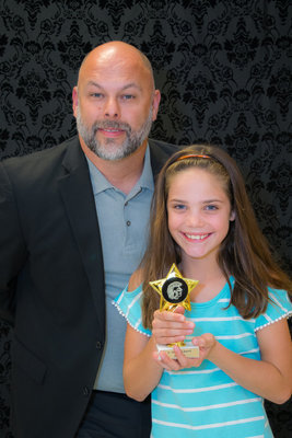 Image: Superintendent Lee Joffre presents Landry Janek with her Junior Gladiator Award.