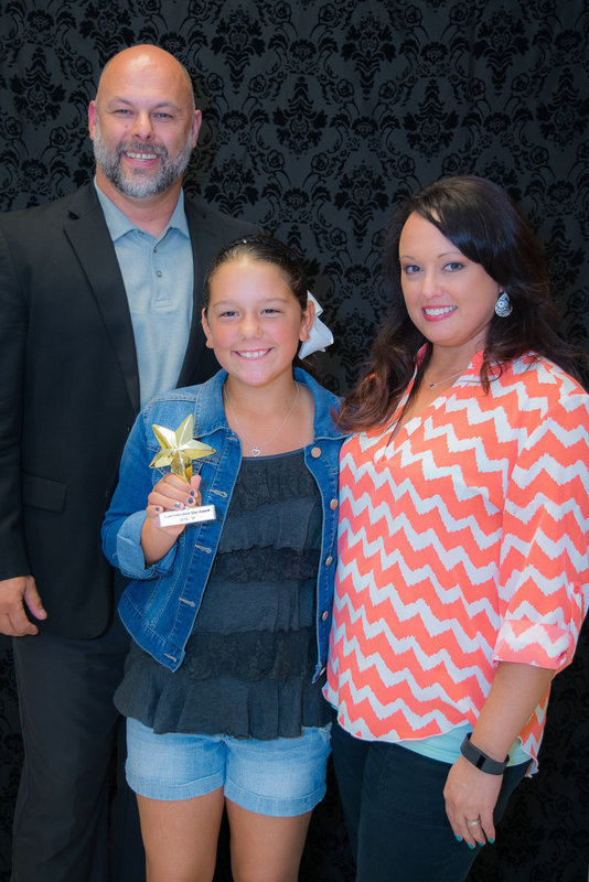 Image: Ella Hudson is happy as she receives the 5th Grade Star Award. (l to r) Lee Joffre, Ella Hudson and her teacher Mrs. Robinson.
