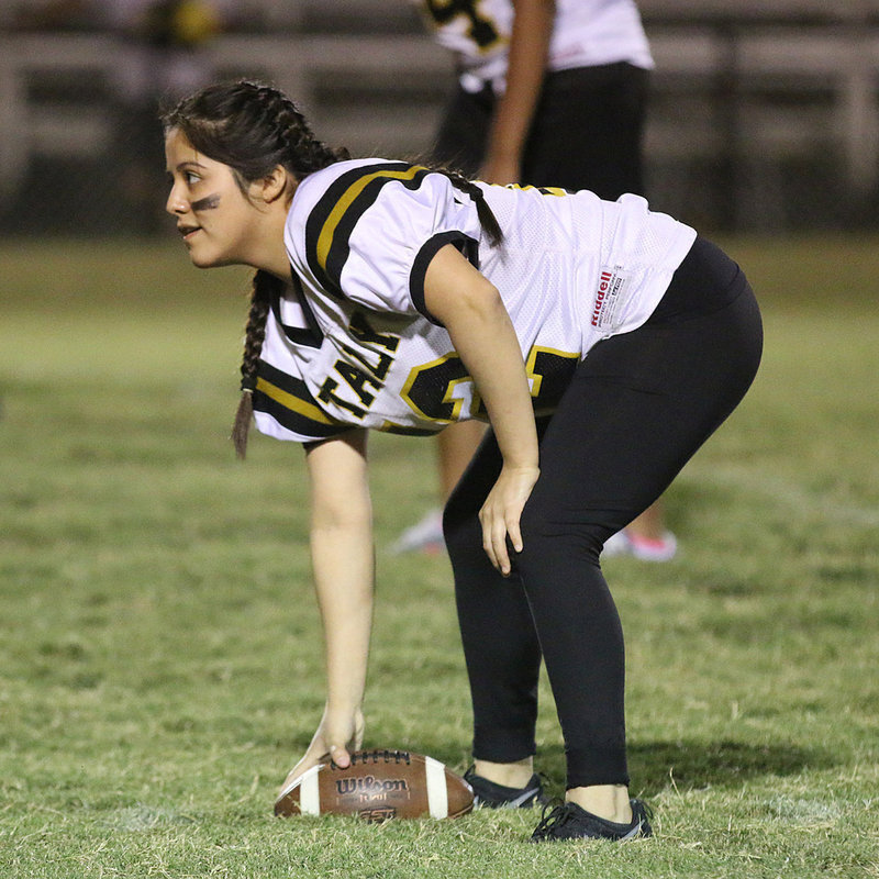 Image: Senior long snapper Kimberly Mata is the ‘center’ of attention in this photo.