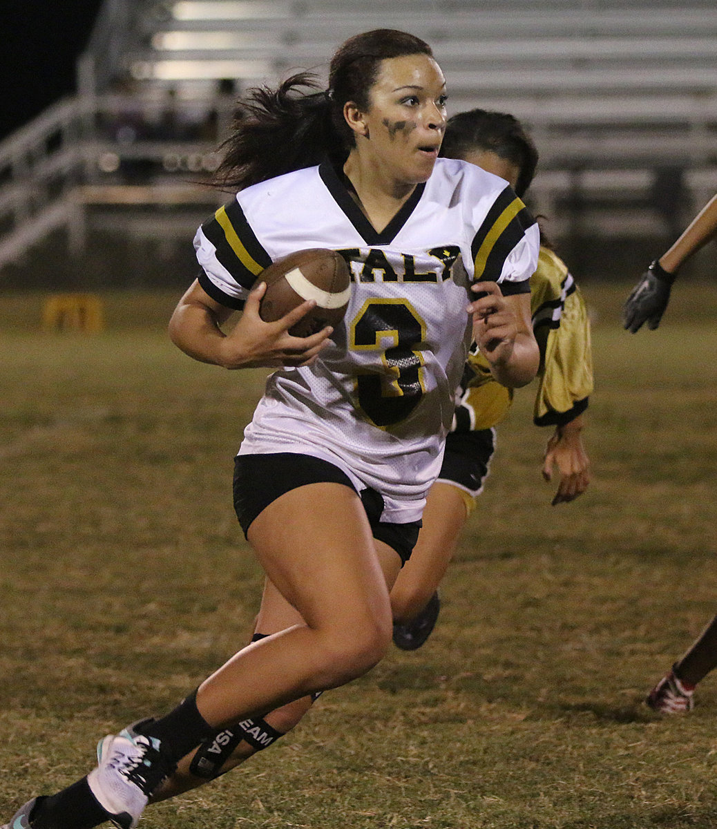 Image: Running back April Lusk helps lead her senior girls to victory with 2 rushing touchdowns in a 24-12 win over the junior girls during the Italy High School 2016 Powder Puff game.