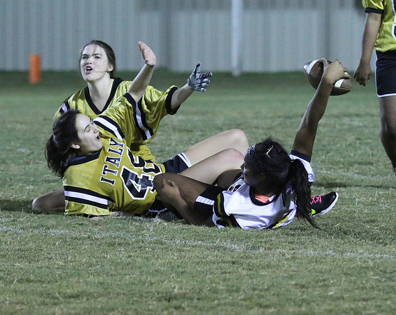Image: A sure pick by junior defender Grace Haight is pulled away for a reception by senior receiver Aarion Copeland who holds the ball up to signal her slick accomplishment. Also defending on the play was Anicka Garcia.