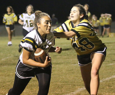 Image: Senior receiver Vanessa Cantu hauls in a pass before being tackled by junior defender Anicka Garcia prior to the end zone.